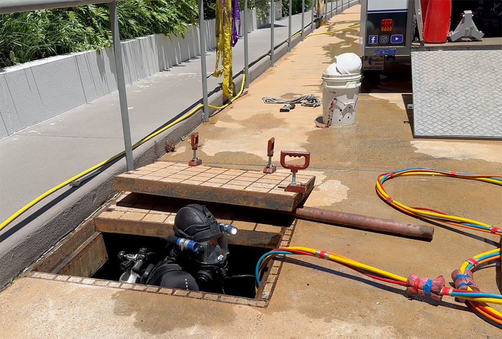 Fire Tanks Australia diver performing contamination diving in an underground fire tank with safety equipment.