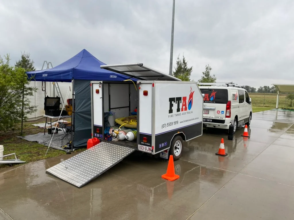 Fire Tanks Australia mobile setup with equipment and vehicles ready for fire tank maintenance on-site.