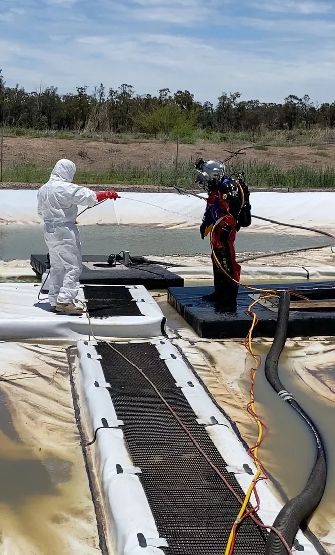 Fire Tanks Australia team performing maintenance and inspection on an industrial fire water tank within a commercial facility.